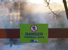 Signs warn people of the dangers of the hot water pools